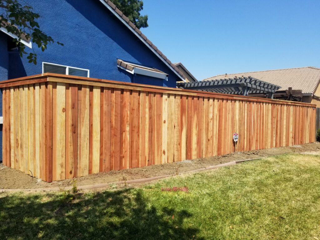 wooden fence agains a blue house