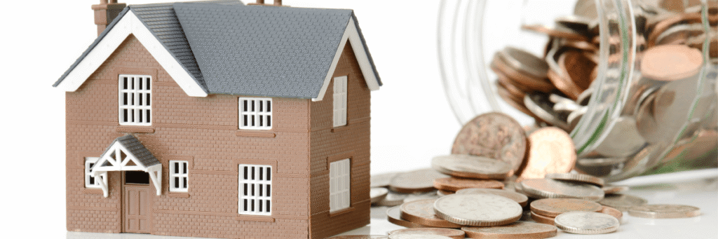 a small house with coins behind it to signify the financing aspect of residential renovations & repairs.