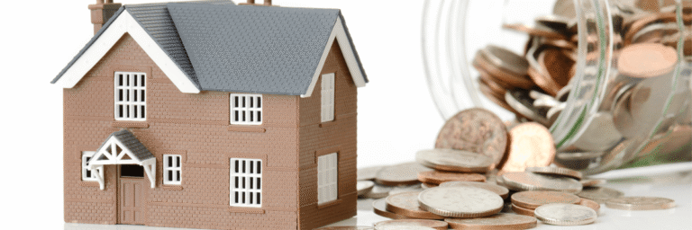 a small house with coins behind it to signify the financing aspect of residential renovations & repairs.